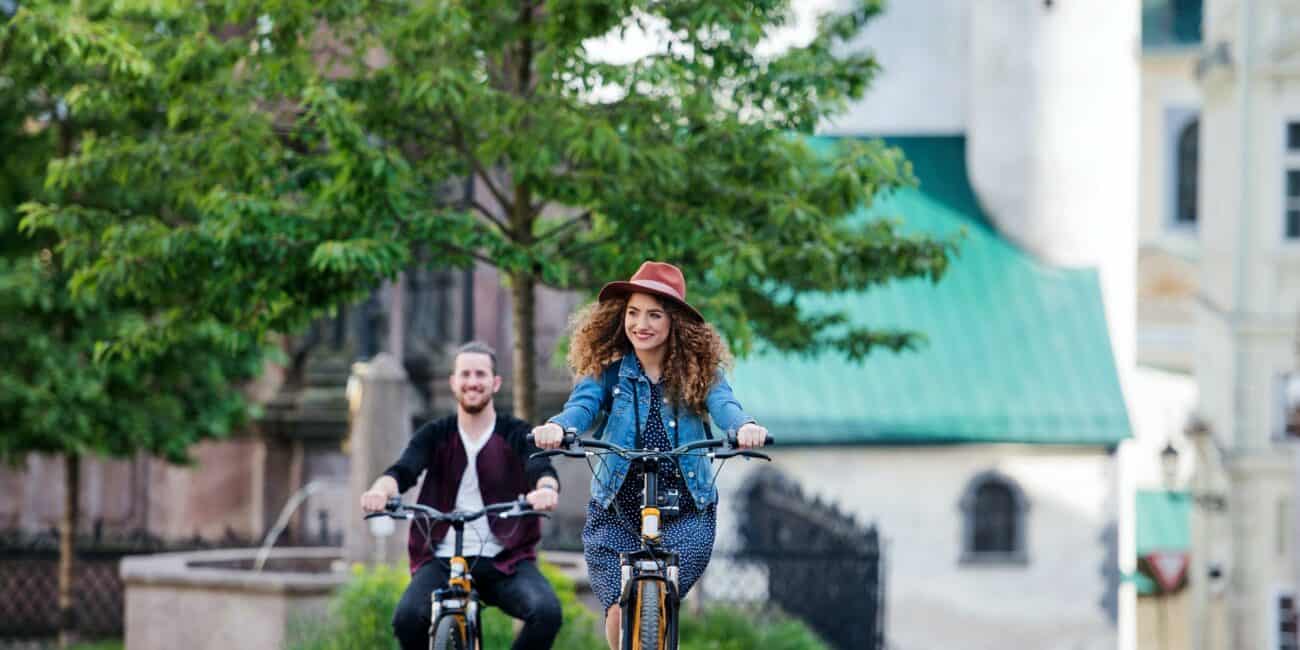 Young tourist couple travellers with electric scooters in small town