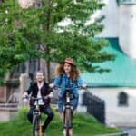 Young tourist couple travellers with electric scooters in small town