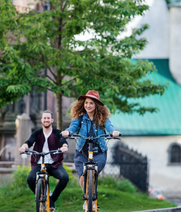 Young tourist couple travellers with electric scooters in small town